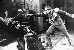 Il grande divo del cinema muto americano Douglas Fairbanks interpreta l'eroe mascherato nel primo successo cinematografico Il segno di Zorro - Immagine in pubblico dominio, fonte Wikimedia Commons