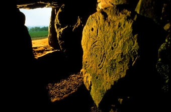 L'interno del Mound of the Hostages di Tara, con la pietra centrale illuminata dal sole - Immagine utilizzata per uso di critica o di discussione ex articolo 70 comma 1 della legge 22 aprile 1941 n. 633, fonte Internet